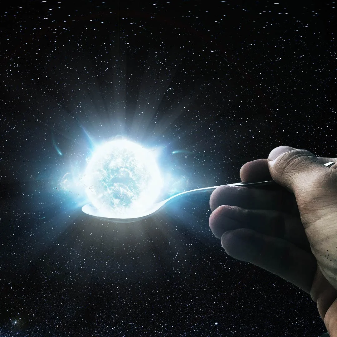 A hand holding a spoon appears to hold a glowing, bright celestial object, resembling a star or supernova, with a backdrop of a star-filled outer space.