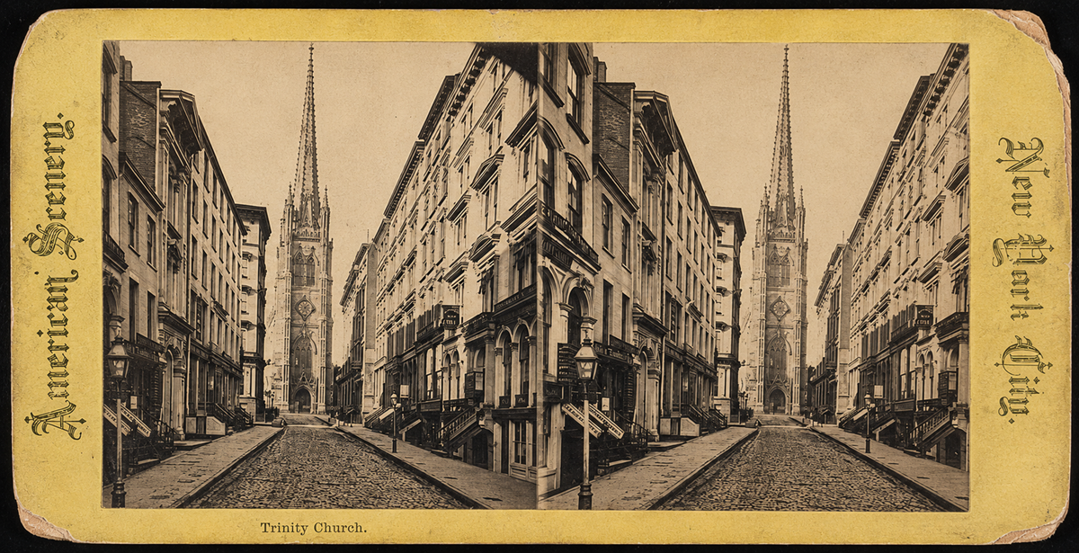 A vintage stereoscopic photo of a cobblestone street in New York City leading to Trinity Church, with tall buildings on both sides and the church’s spire visible in the distance. The image has a yellow border.
