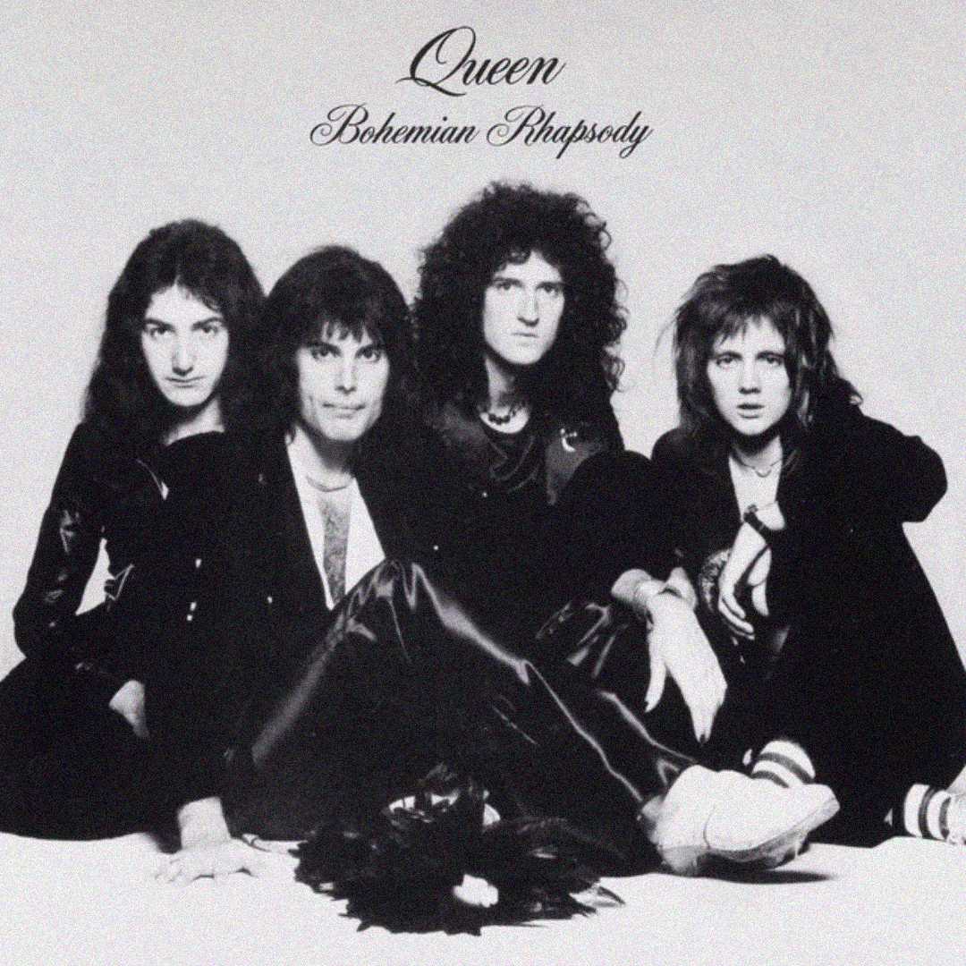 Four men from the band Queen sit together against a plain background beneath the text "Queen Bohemian Rhapsody." They wear dark clothing and have long hair, looking directly at the camera.