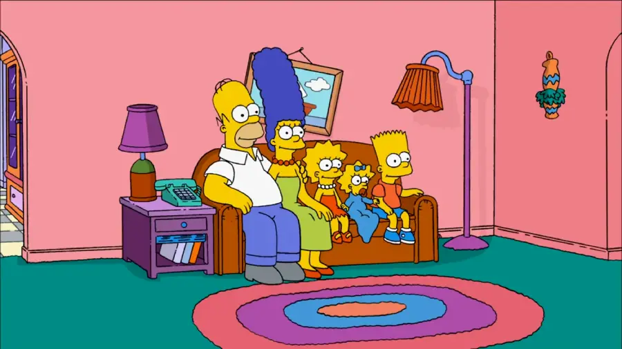 The Simpson family—Homer, Marge, Lisa, Maggie, and Bart—sit on their brown living room couch, watching TV. The room has pink walls, a green carpet, and colorful furnishings.