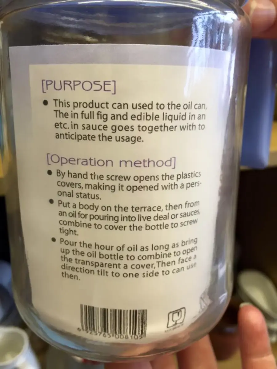 A glass bottle with a label showing instructions in English for its purpose and operation, including steps for opening and using the bottle for oil or sauce. The text contains several grammatical errors.