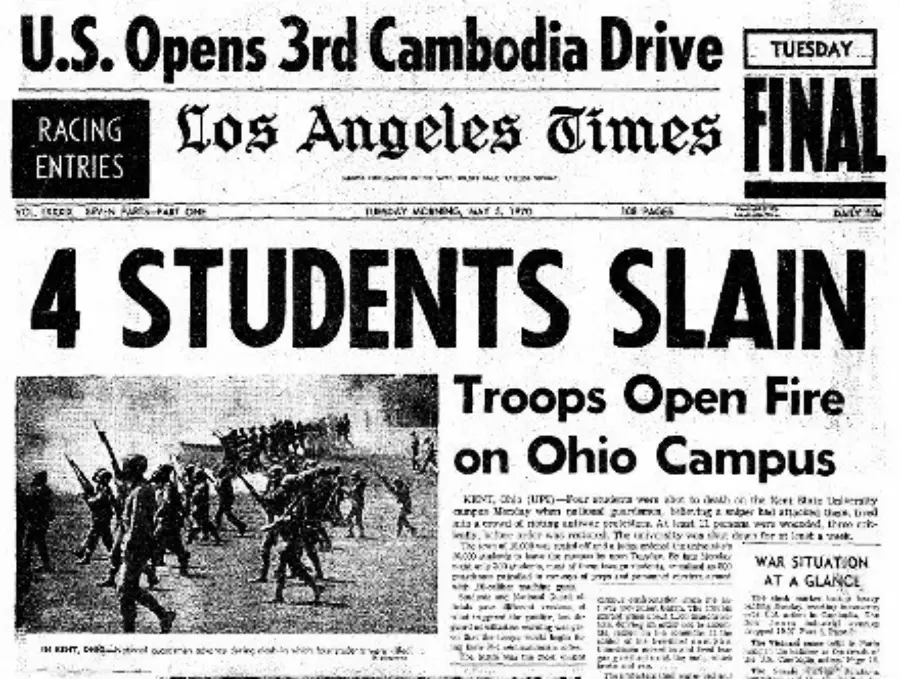 Front page of the Los Angeles Times with the headline "4 STUDENTS SLAIN" and a subheading "Troops Open Fire on Ohio Campus," featuring a photo of soldiers confronting students.