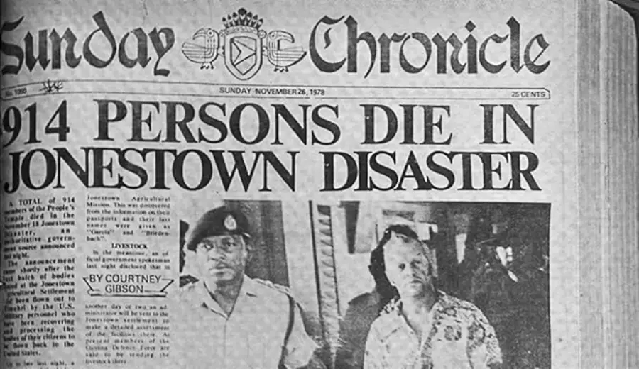 Black and white newspaper headline reads "914 PERSONS DIE IN JONESTOWN DISASTER" with two men, one in a uniform and one in a patterned shirt, pictured below the headline.