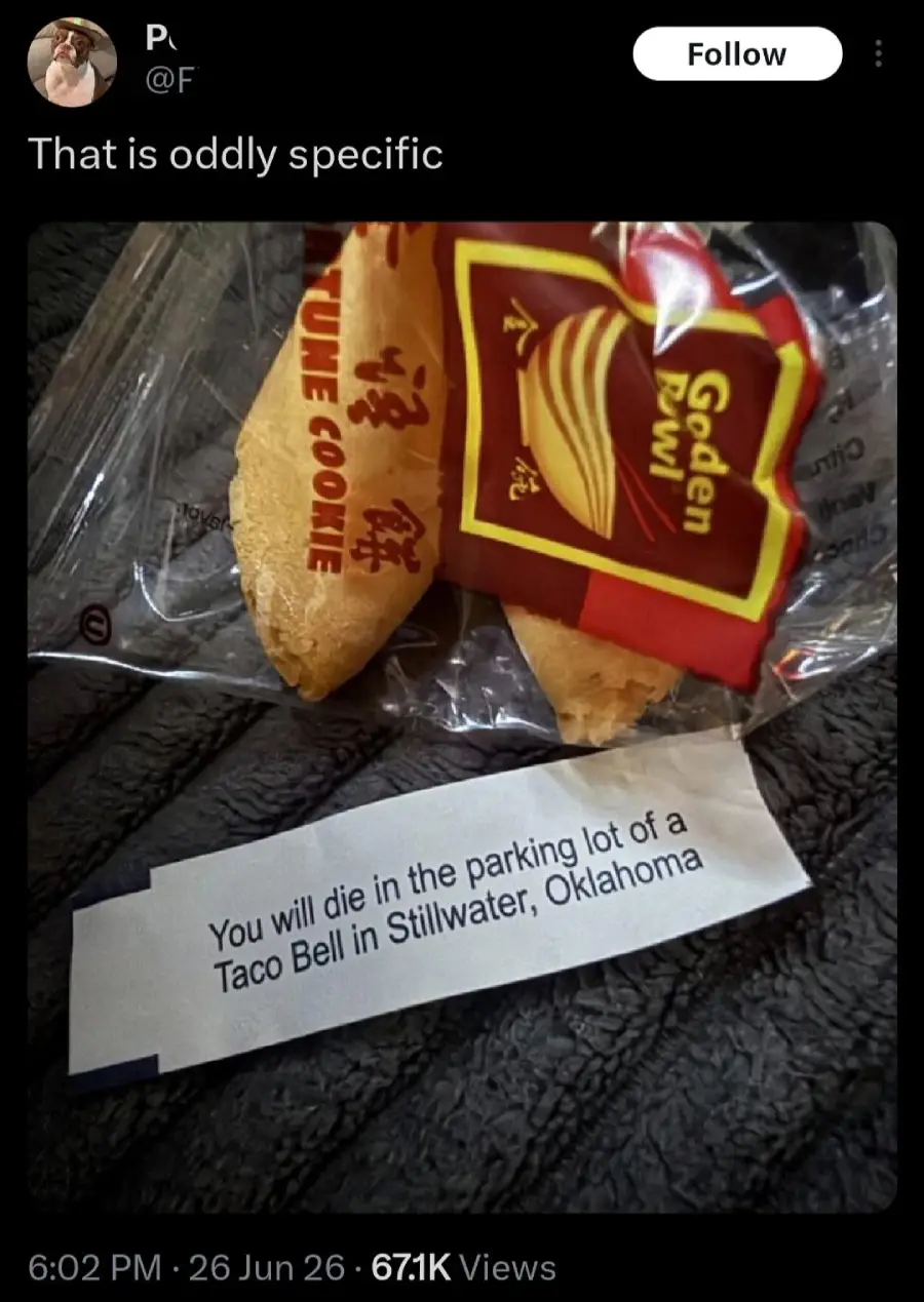 A fortune cookie with its wrapper and a fortune slip that reads, "You will die in the parking lot of a Taco Bell in Stillwater, Oklahoma," is shown on a textured surface.