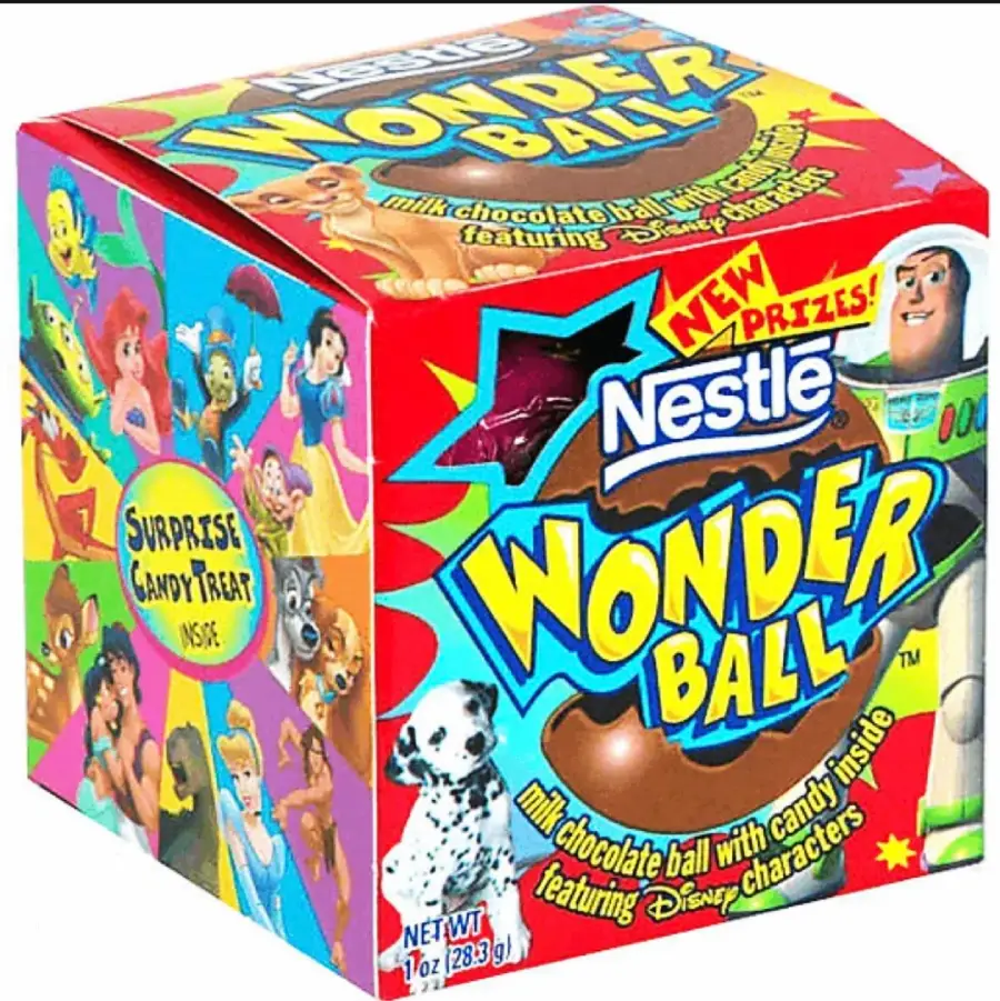 A colorful Nestlé Wonder Ball box with Disney characters on the sides. Text reads "milk chocolate ball with candy inside" and "NEW PRIZES!" A picture of the chocolate ball and a dalmatian are also visible.