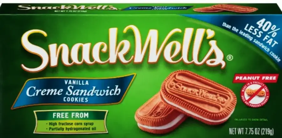 A green box of SnackWell's Vanilla Creme Sandwich Cookies, showing two cookies with "SnackWell's" embossed on top. Labels indicate “Peanut Free” and “40% less fat,” and highlight being free from high fructose corn syrup.