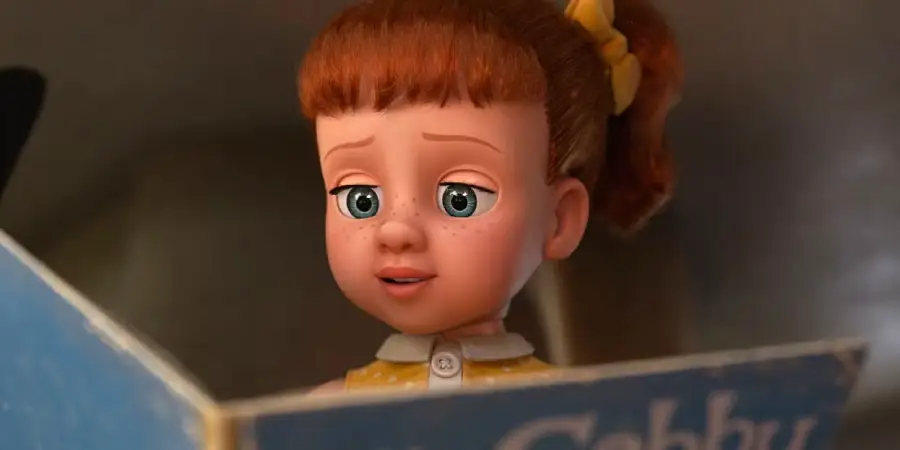 Animated doll with red hair in pigtails and a yellow bow, wearing a yellow dress with a white collar, looks thoughtfully at an open blue book.