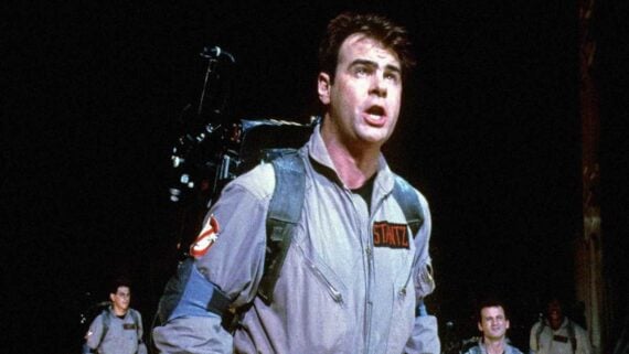 Dan Aykroyd wearing his Ghostbusters uniform in a promotional image from the classic supernatural comedy film.