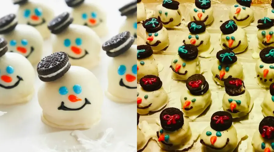 Oreo snowman treats with white chocolate coating, mini Oreo hats, blue eyes, orange noses, and smiling faces. Some are decorated with bows and buttons, arranged on a white surface.