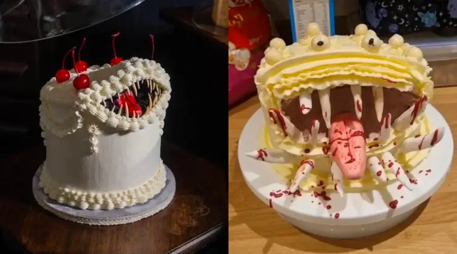 Two cakes decorated to look like monsters with large open mouths, sharp teeth, and cherries or candy for details. One cake has cherries as eyes, while the other has a pink tongue and yellow icing.