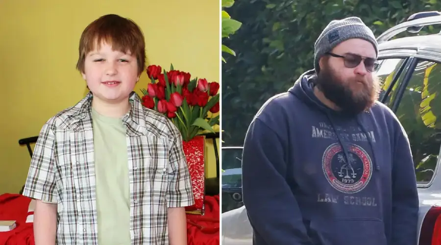 Side-by-side photos of the same person: on the left as a child with short hair, wearing a plaid shirt, and on the right as an adult with a beard, glasses, beanie, and dark hoodie, standing outdoors near a car.