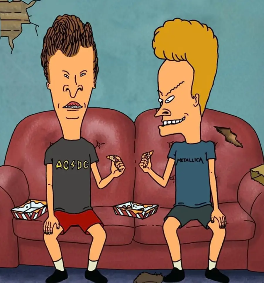 Two cartoon characters with exaggerated faces sit on a worn red couch, holding slices of pizza. One wears an AC/DC shirt and red shorts, the other a Metallica shirt and black shorts. Pizza boxes and crumbs are on the couch and floor.