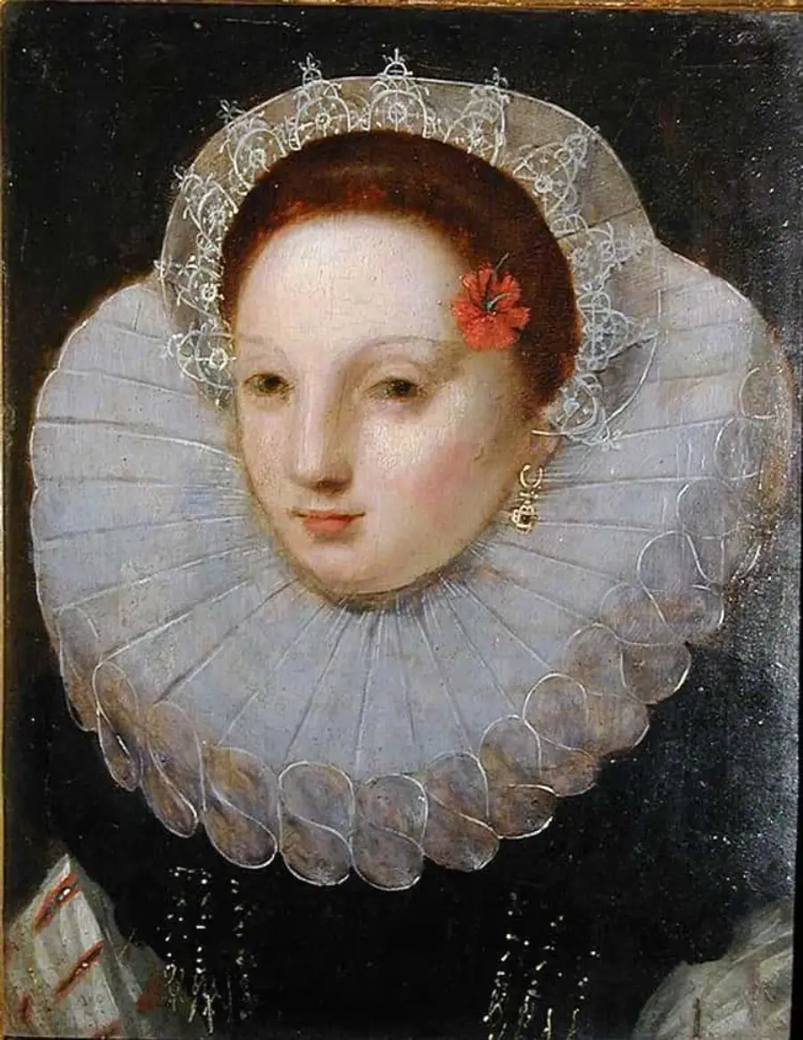 Portrait of a woman in Elizabethan attire with a large, ruffled white lace collar, pale skin, a red flower in her hair, gold earring, and a dark background.