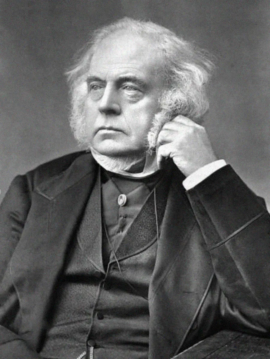 An older man with white hair and bushy sideburns, wearing a formal suit, sits with his hand resting on his face, looking off to the side thoughtfully in a black-and-white portrait.