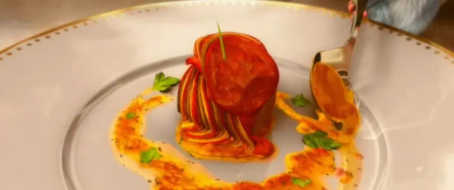 A plated gourmet dish featuring a neatly stacked tower of thinly sliced vegetables, drizzled with vibrant sauce and garnished with fresh herbs, with a fork beside it on an elegant white plate with a gold rim.