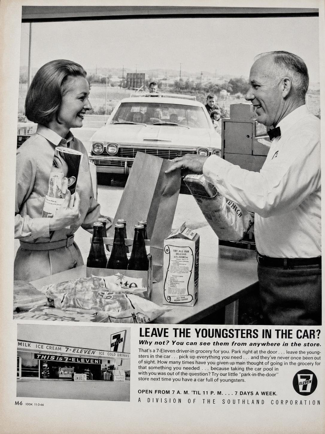 A woman and a man smile while bagging groceries at a 7-Eleven store counter. The man is placing items in a paper bag; two glass bottles and cereal are visible. A car is parked outside the store window behind them.