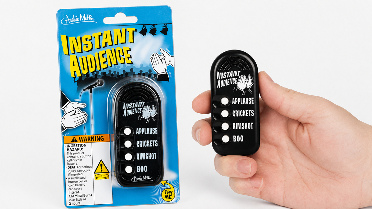 A hand holds a novelty “Instant Audience” sound effects device with buttons for applause, crickets, rimshot, and boo. The packaged product is shown next to the hand.