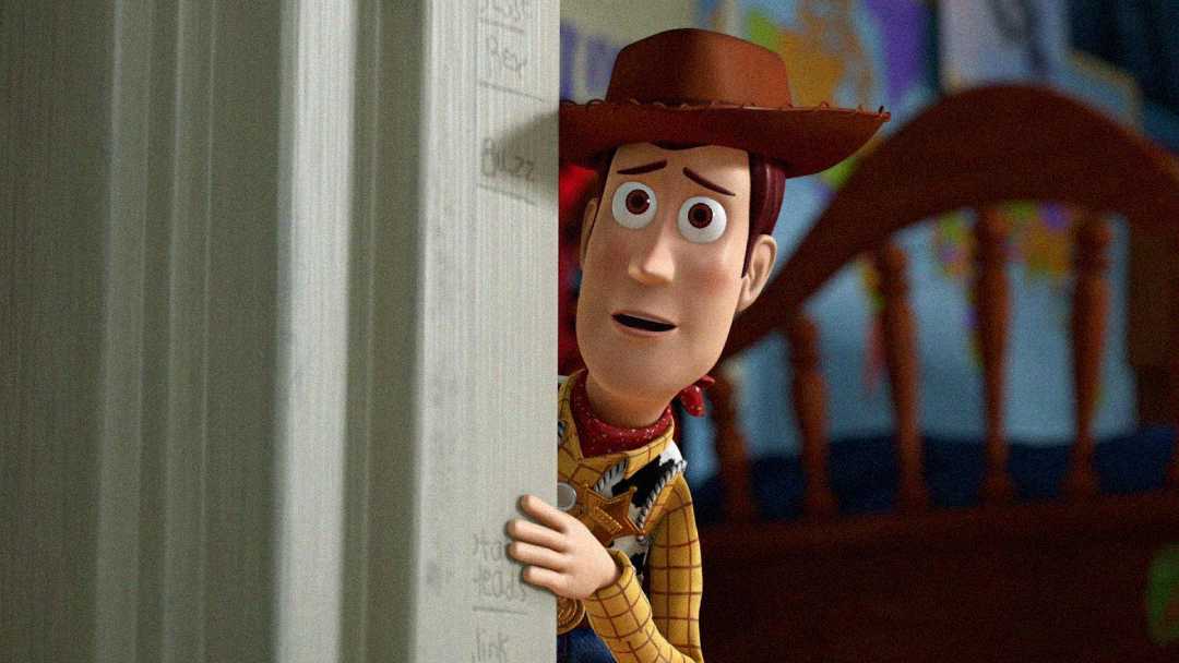 Woody, a cowboy doll from Toy Story, peeks anxiously from behind a doorframe in a child's bedroom, with a bed and colorful wall decor visible in the background.