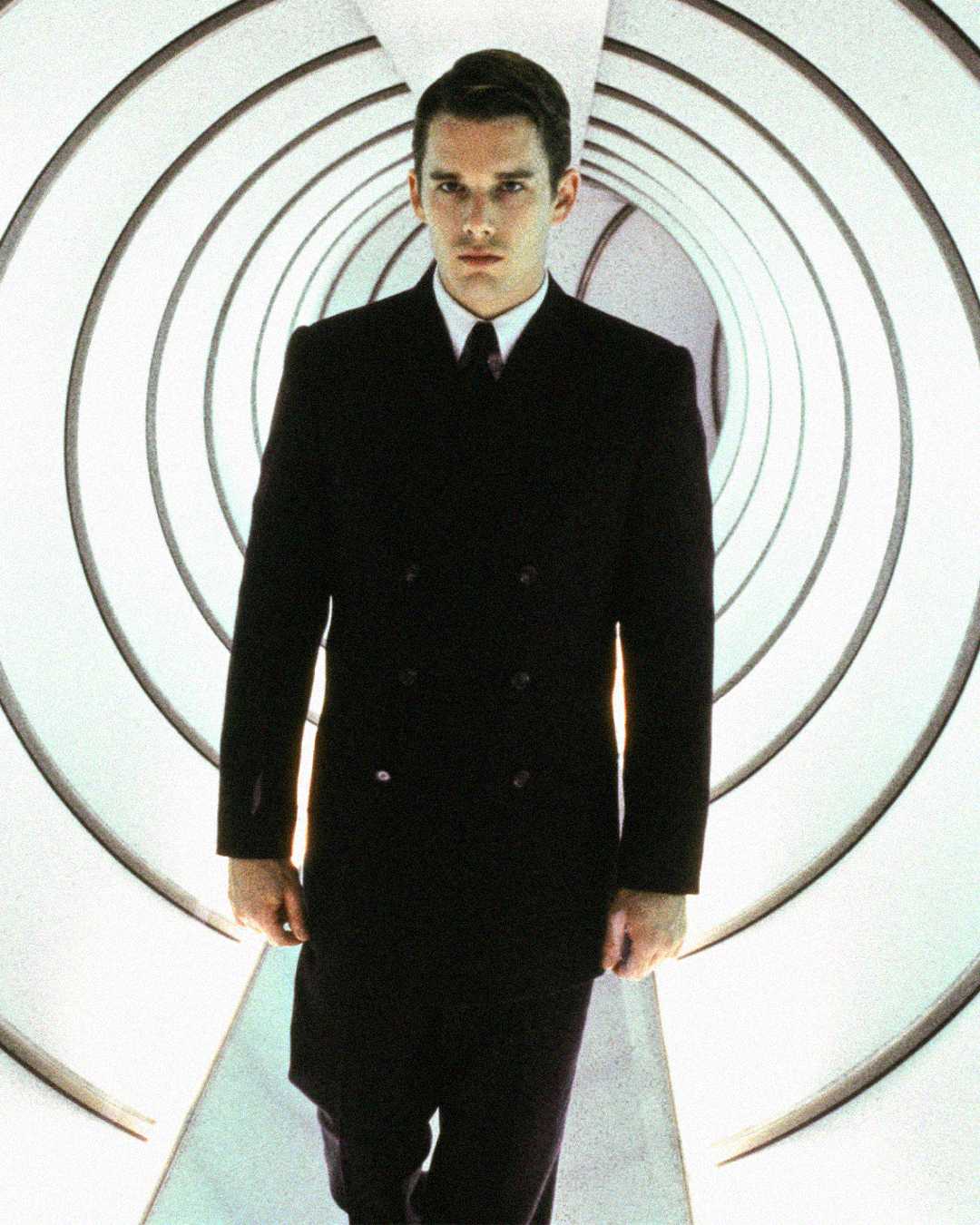 A man in a dark suit walks confidently through a futuristic, tunnel-like hallway with circular, concentric patterns and bright lighting.