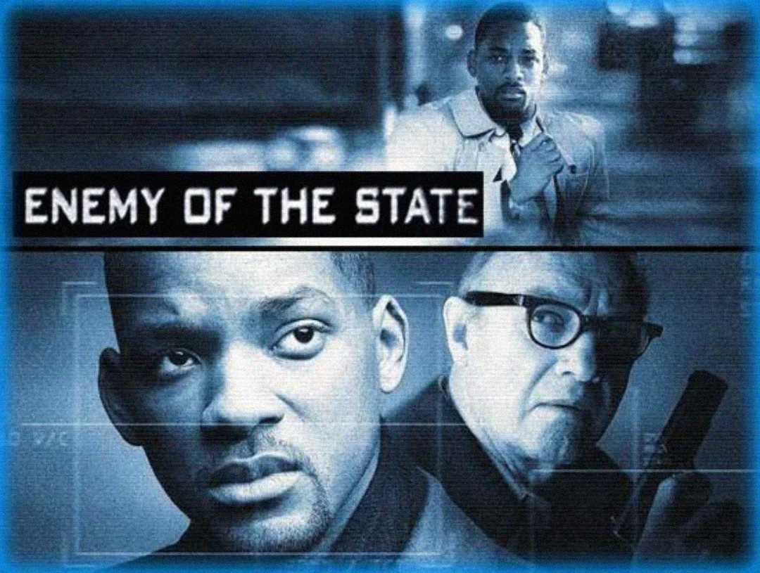 Movie poster for "Enemy of the State" featuring a close-up of a serious-faced man, another man with glasses holding a device, and a scene of a man running at the top. The movie title is centered in bold white text.