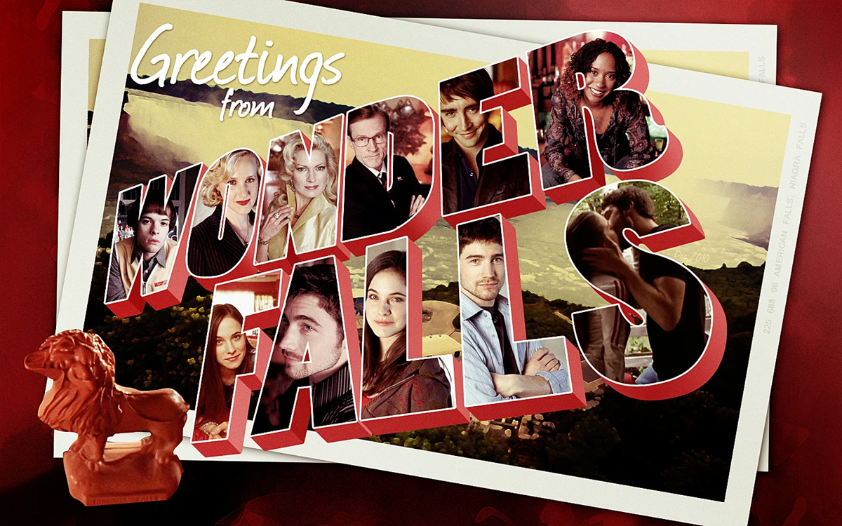 A postcard reads "Greetings from Wonderfalls" with photos of various characters inside bold letters. A small red lion figurine is in the bottom left corner. The background shows a scenic view and other postcards.
