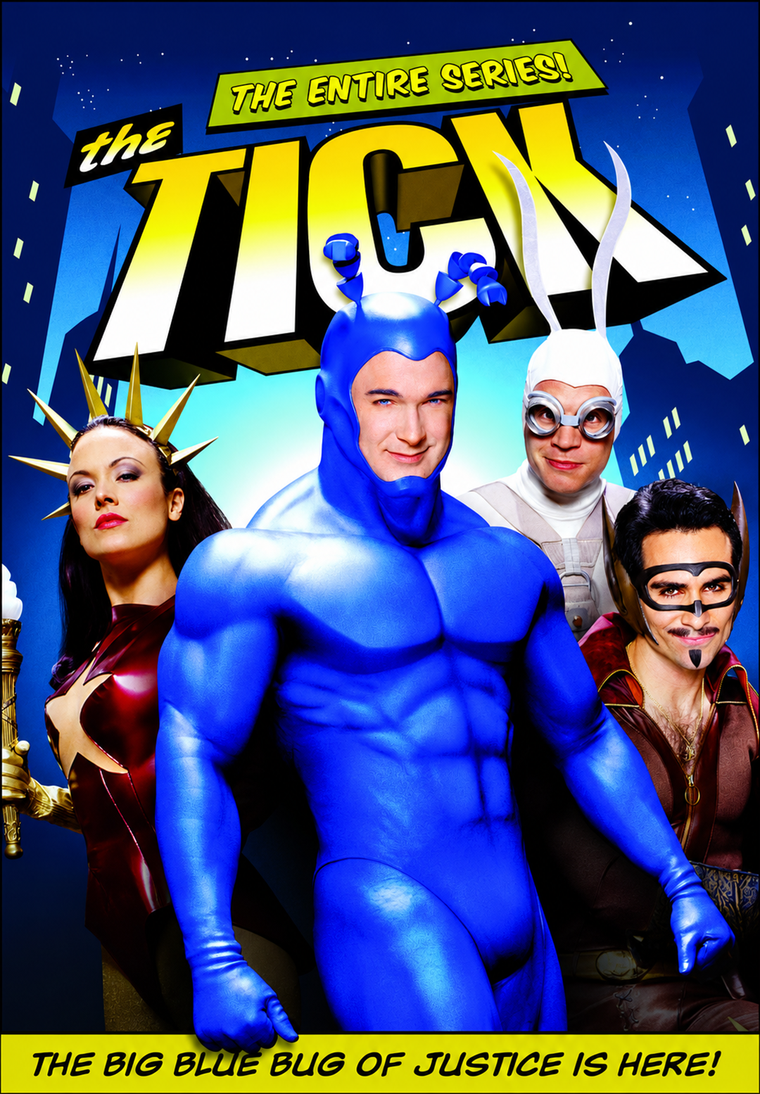 Four people in superhero costumes pose in front of a city skyline at night. The central figure wears a bright blue suit with antennae. Bold yellow text reads "The Tick: The Entire Series!" and a tagline appears at the bottom.