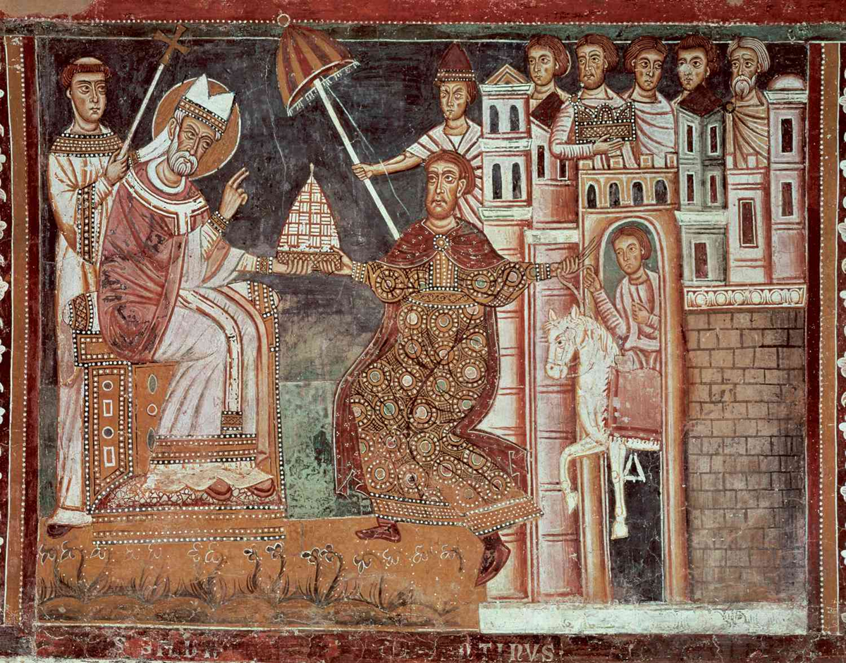 Medieval fresco showing a pope handing a model of a church to an emperor in ornate robes; officials and guards watch from buildings and city walls in the background.