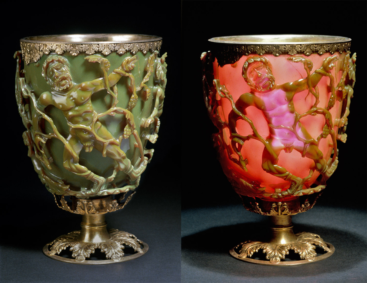 An ornate Roman cup, the Lycurgus Cup, shown lit from the front (green) and from behind (red), with intricate scenes of figures and vines on its surface.
