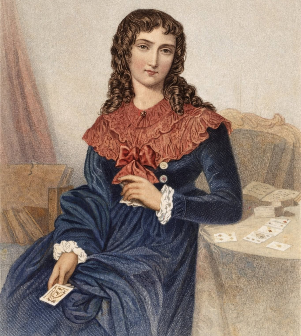 A woman in a blue dress with a red collar sits by a table holding a playing card. Other cards are spread out on the table beside her. She has curly brown hair and a calm expression.