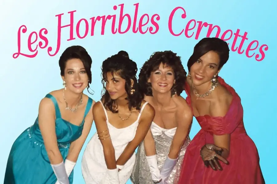 Four women dressed in colorful formal gowns and white gloves pose and smile in front of a blue background with the pink text "Les Horribles Cernettes" above them.