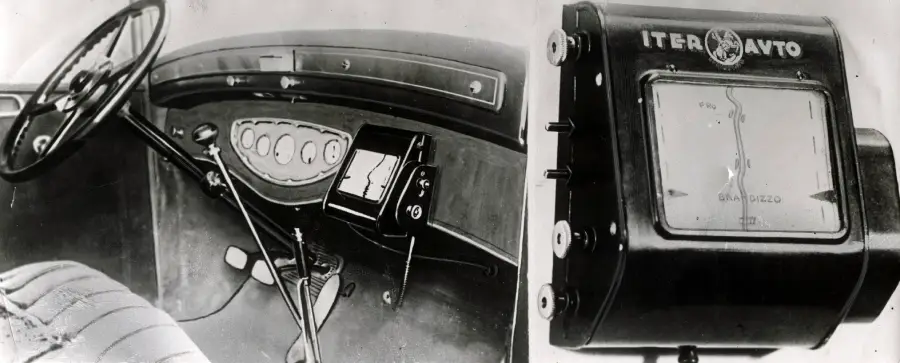 A vintage car dashboard with a steering wheel, pedals, and an old navigation device labeled “Iter Avto” mounted near the center. An enlarged view of the navigation device appears on the right.