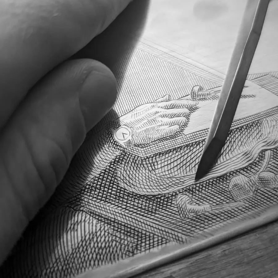 A hand holds a burin while engraving detailed lines onto a metal plate, depicting another hand and various objects in fine crosshatch patterns.