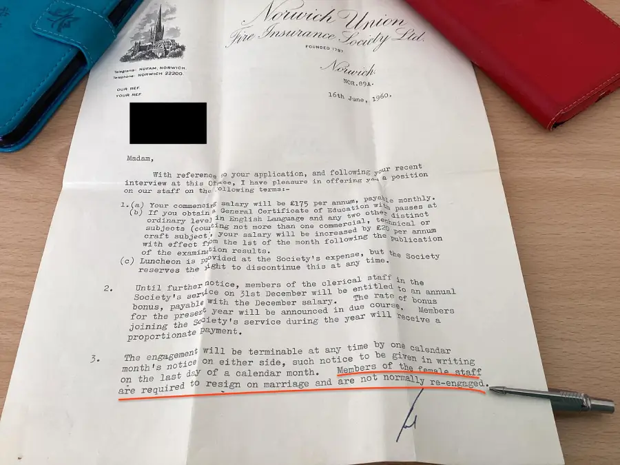 A typed letter on Norwich Union letterhead sits on a desk with red and blue wallets nearby. Text is highlighted at the bottom stating staff must resign on marriage and are not usually re-engaged.