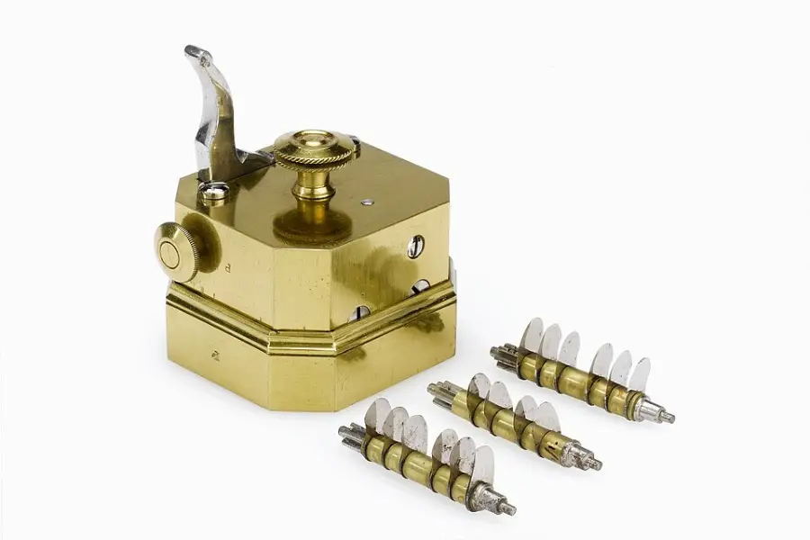 A brass mechanical device with a lever and knob, accompanied by three sets of small metal blades arranged on rods, all on a white background.