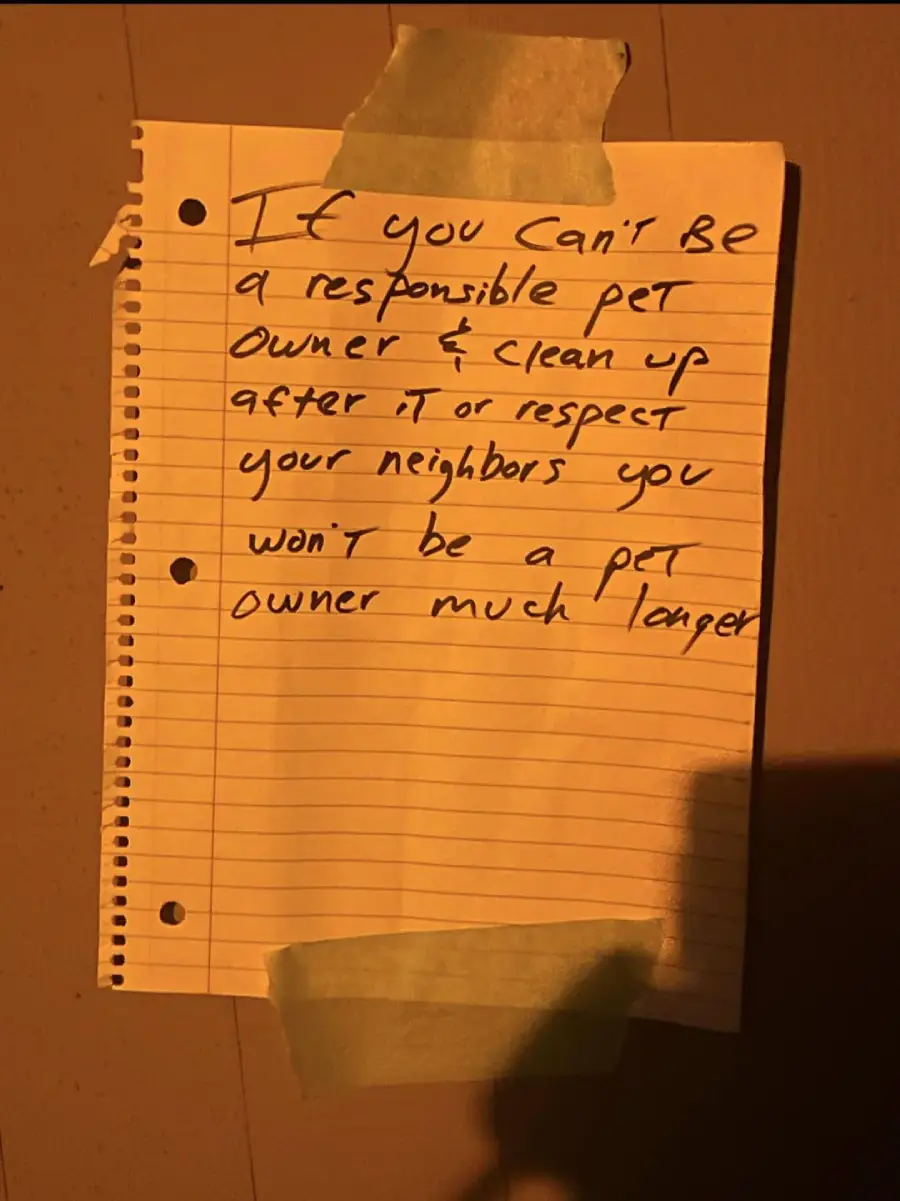 A handwritten note taped to a wall reads: "If you can't be a responsible pet owner & clean up after it or respect your neighbors you won't be a pet owner much longer.