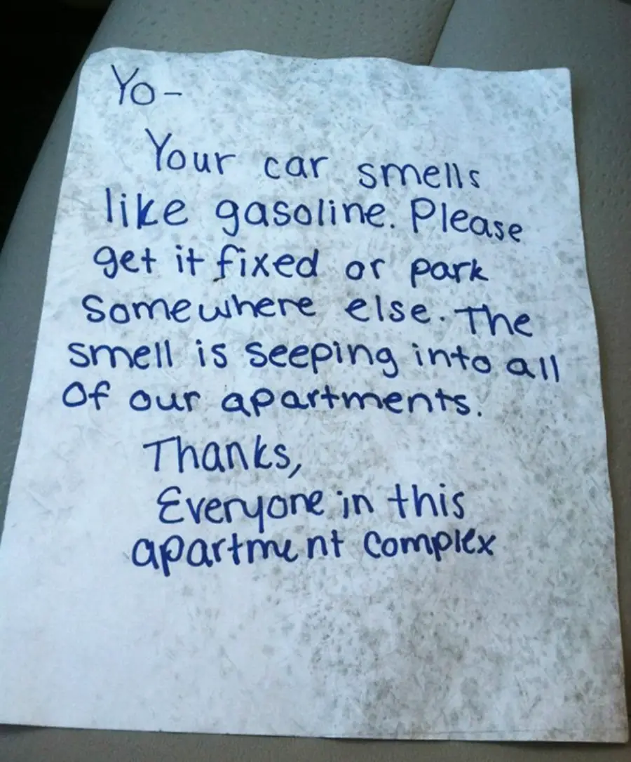 A handwritten note reads: "Yo—Your car smells like gasoline. Please get it fixed or park somewhere else. The smell is seeping into all of our apartments. Thanks, everyone in this apartment complex.