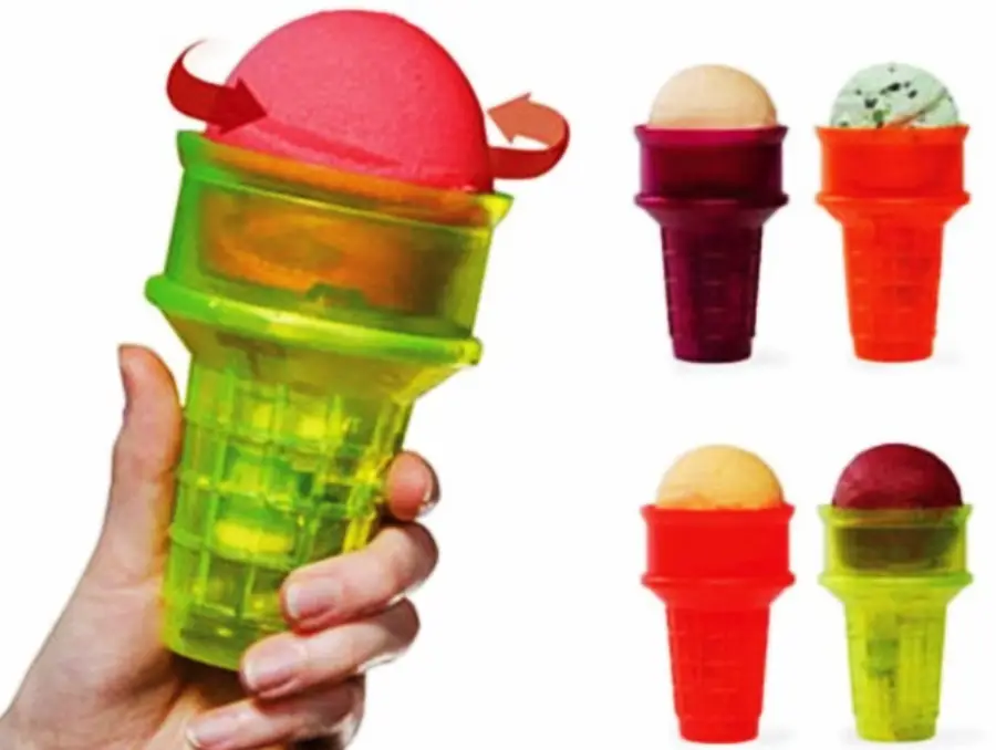 A hand holds a green plastic cone-shaped ice cream holder with a rotating top. Three more colorful holders with different ice cream scoops are shown on the right.