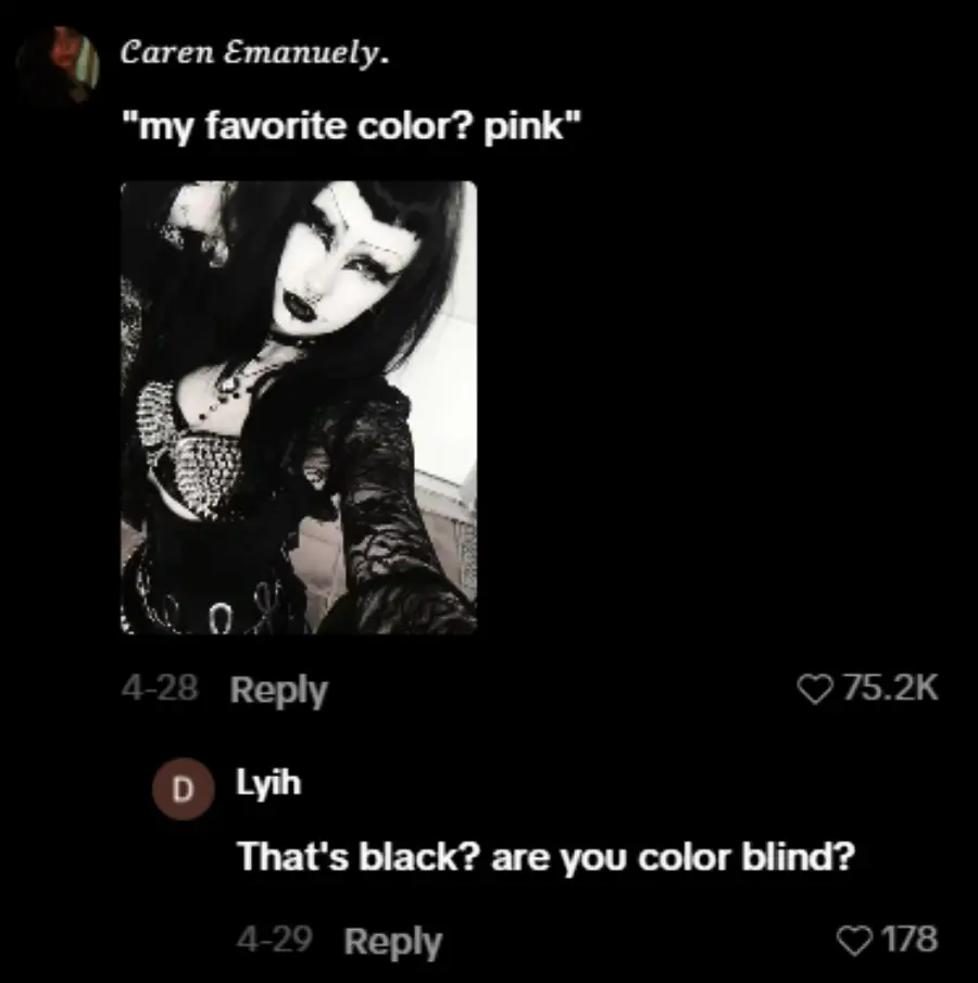 A person dressed in black gothic clothing takes a selfie. Text above says their favorite color is pink. A comment below questions this, pointing out the outfit is black.