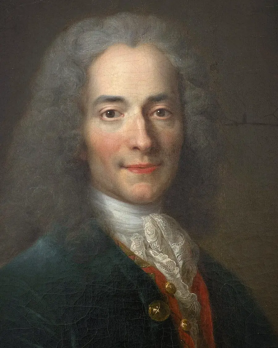 Portrait of a man with long gray hair, wearing a dark coat, white lace cravat, and red waistcoat, gazing forward with a slight smile against a dark background.