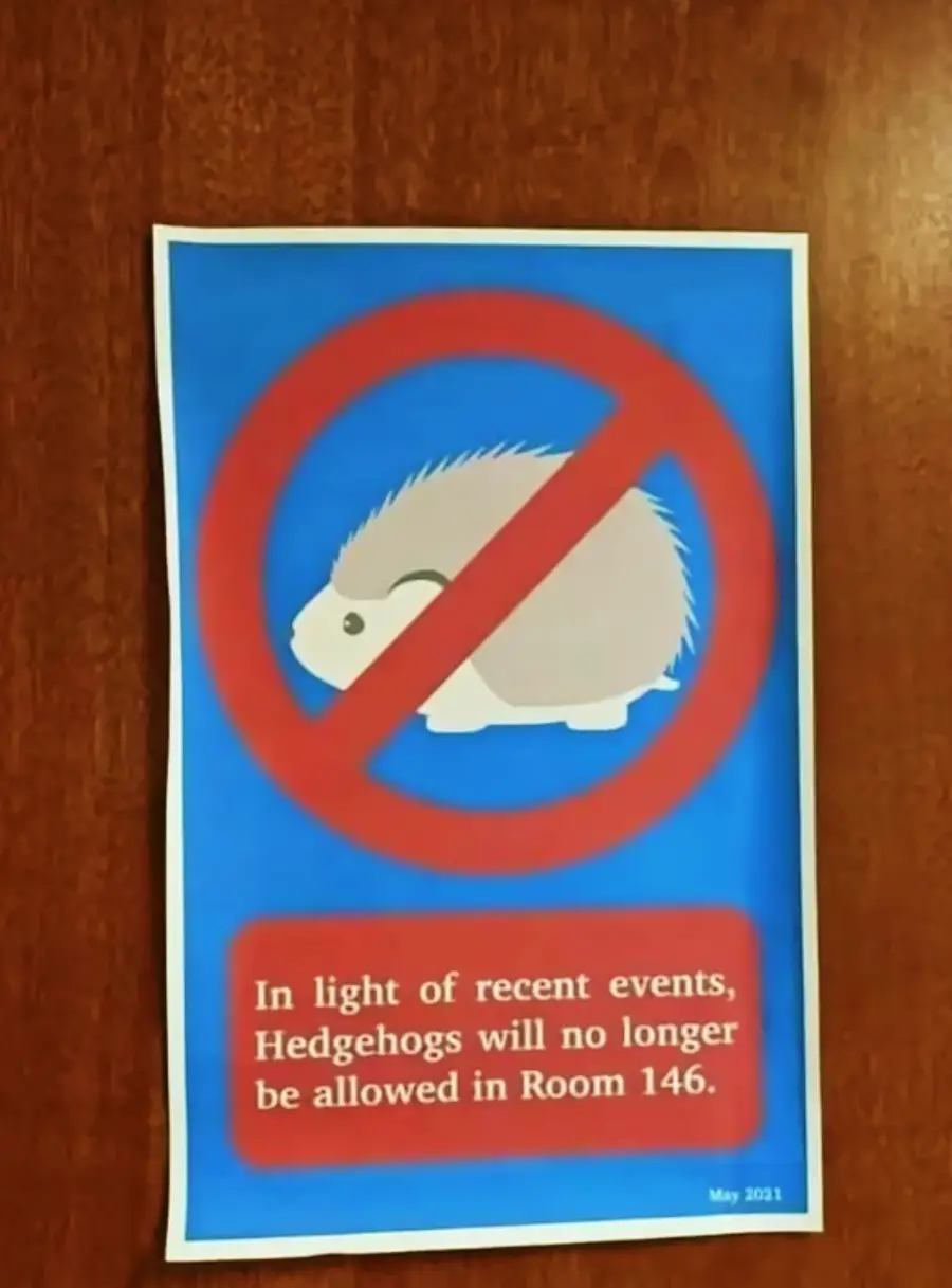 A sign with a drawing of a hedgehog crossed out by a red prohibition symbol. The text below reads: "In light of recent events, Hedgehogs will no longer be allowed in Room 146.