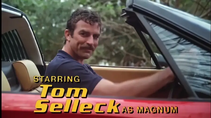 A man with a mustache sits in a red convertible, smiling at the camera. Text reads "Starring Tom Selleck as Magnum.