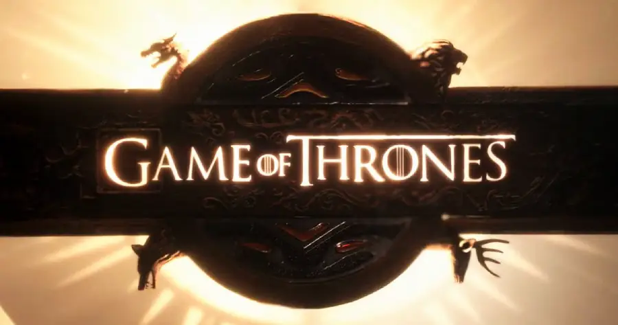 The "Game of Thrones" title logo is displayed in glowing gold, framed by dragon, lion, and stag symbols, with a radiant sunburst in the background.