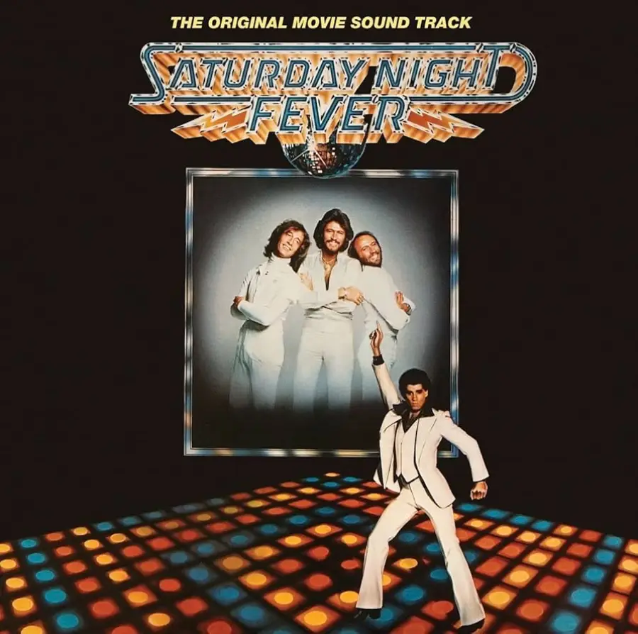 Album cover for "Saturday Night Fever" soundtrack featuring four men in white suits, three posing and one dancing on a colorful, lit disco floor under the title text.