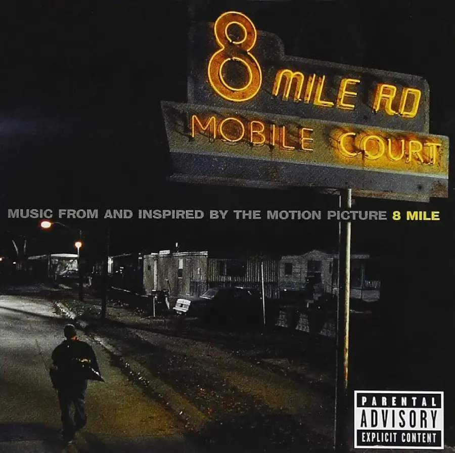 A person walks alone down a dim street at night near a glowing "8 Mile Rd Mobile Court" sign, with trailer homes in the background. The image is the album cover for the "8 Mile" movie soundtrack.