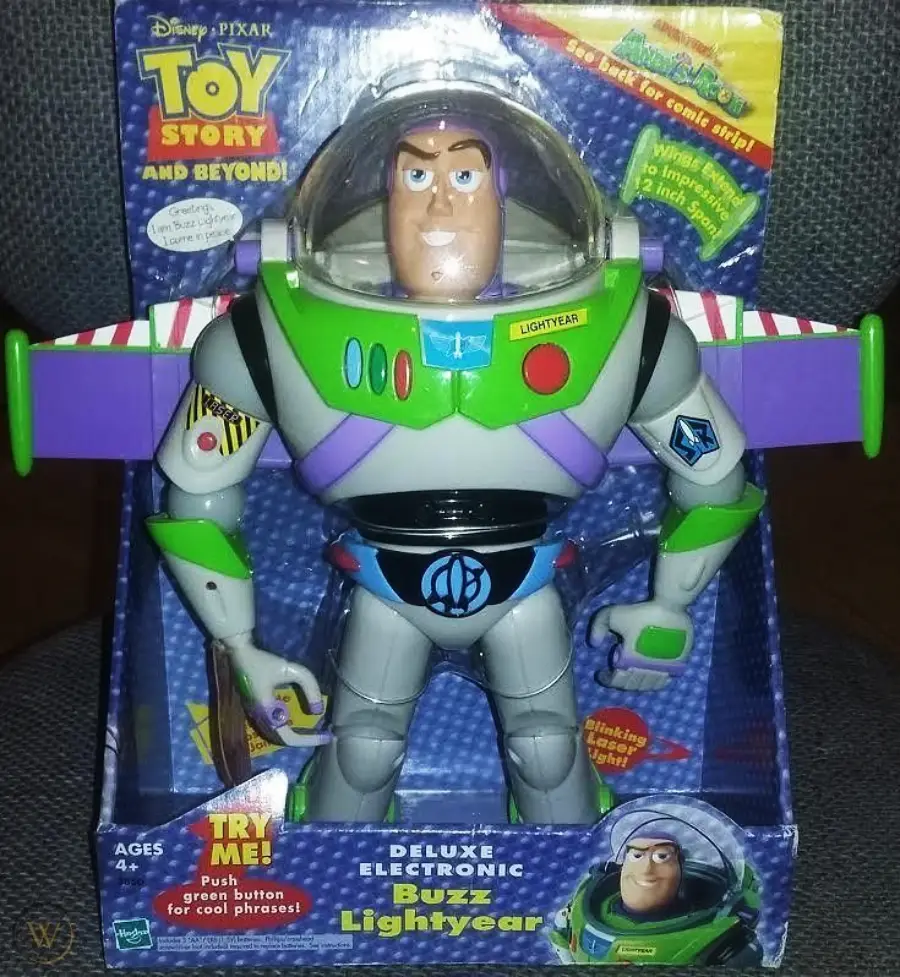 A boxed Disney Pixar Toy Story Deluxe Electronic Buzz Lightyear action figure, featuring movable arms and buttons, with colorful packaging and a "Try Me!" button for phrases.