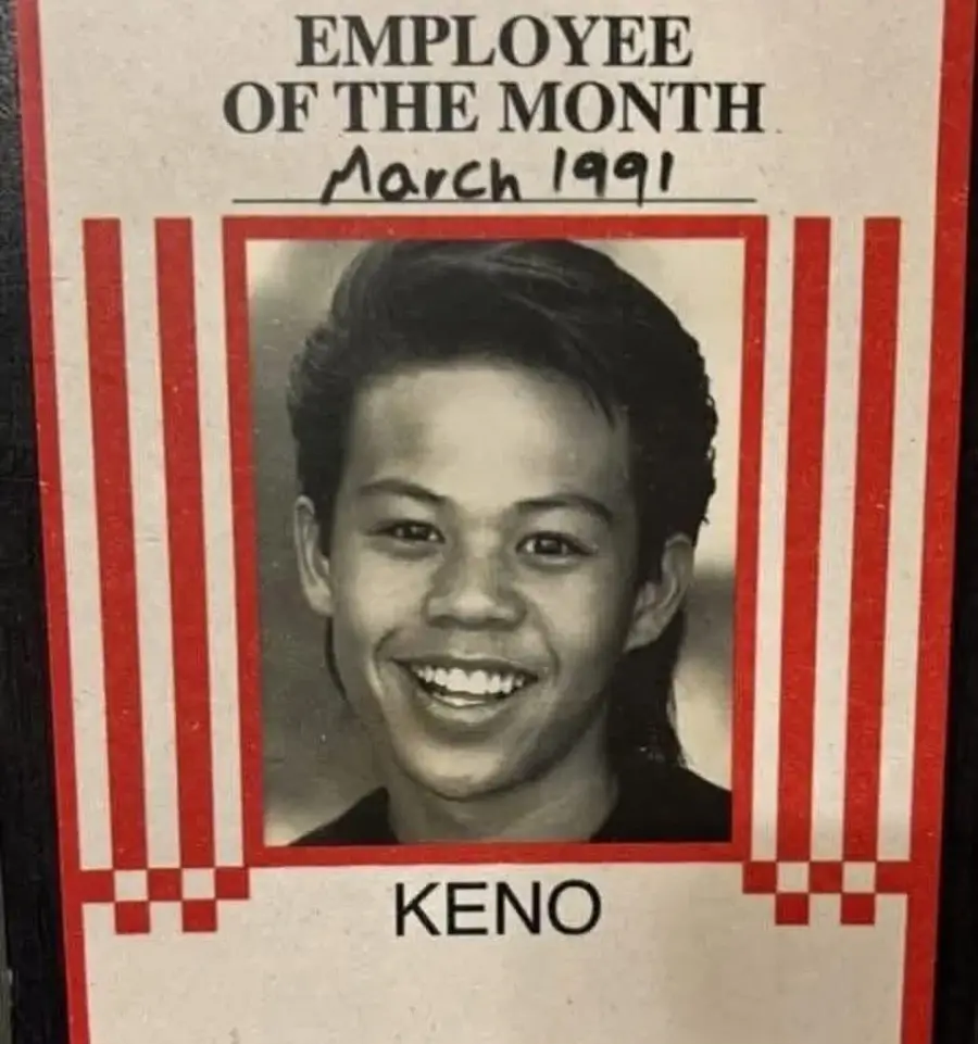 Black-and-white photo of a smiling young person with short hair, labeled "Employee of the Month March 1991." The name "Keno" appears below the photo, framed by red vertical stripes.