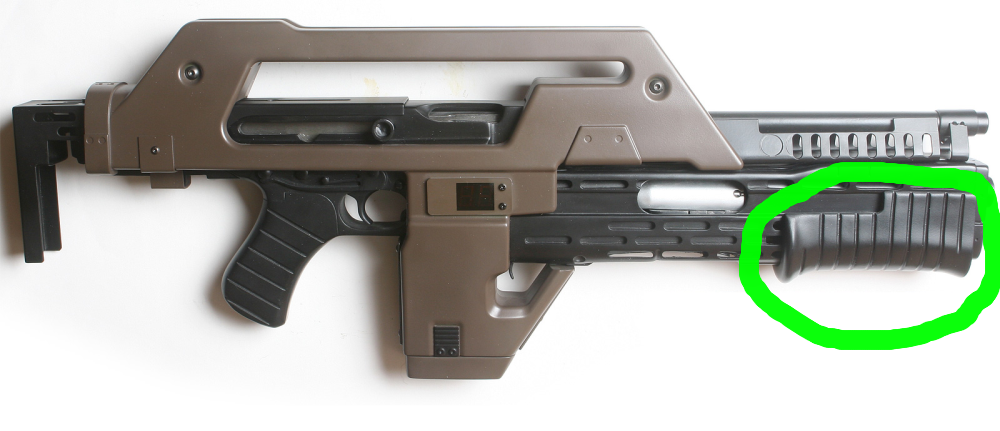 A sci-fi style prop gun with a green circle highlighting the black ribbed grip section at the front.