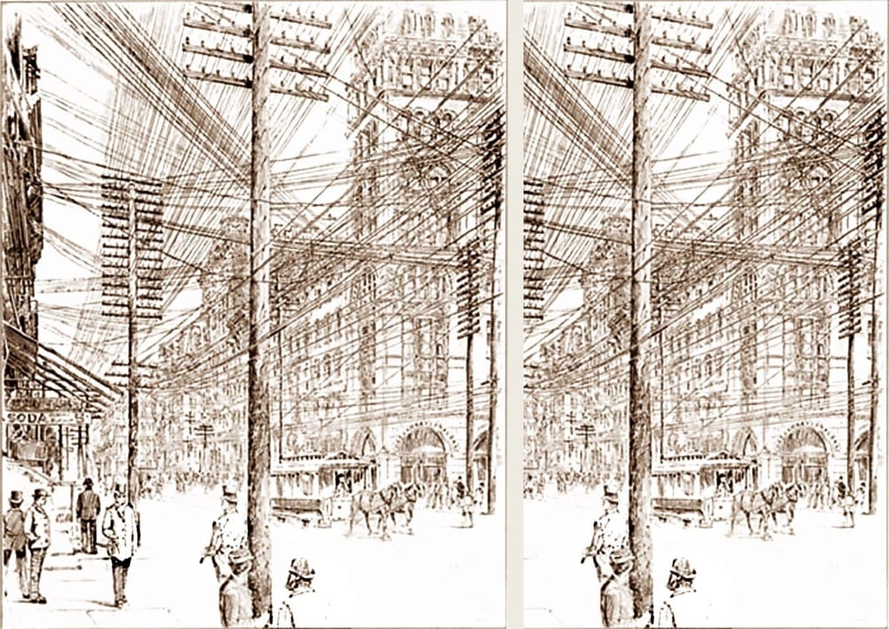 Sepia-toned city street scene with numerous telephone wires crisscrossing above. People walk along the sidewalks, and streetcars and horse-drawn carriages travel the road. Tall poles hold tangled wires overhead.