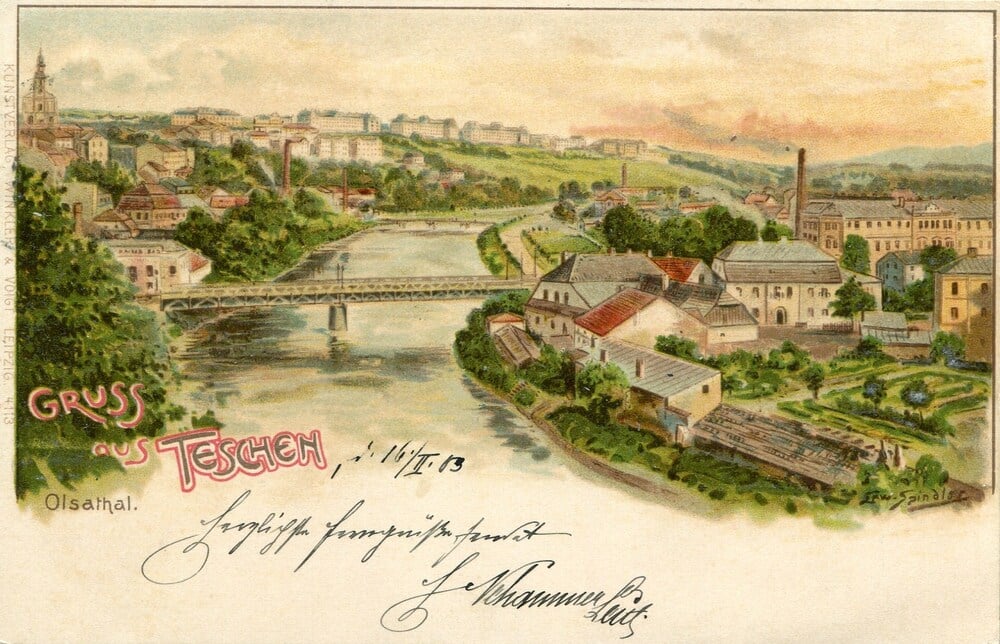 A vintage postcard illustration of a town by a river, with a bridge, buildings, smokestacks, green hills, and handwritten text reading “Gruss aus Teschen” and additional cursive writing at the bottom.