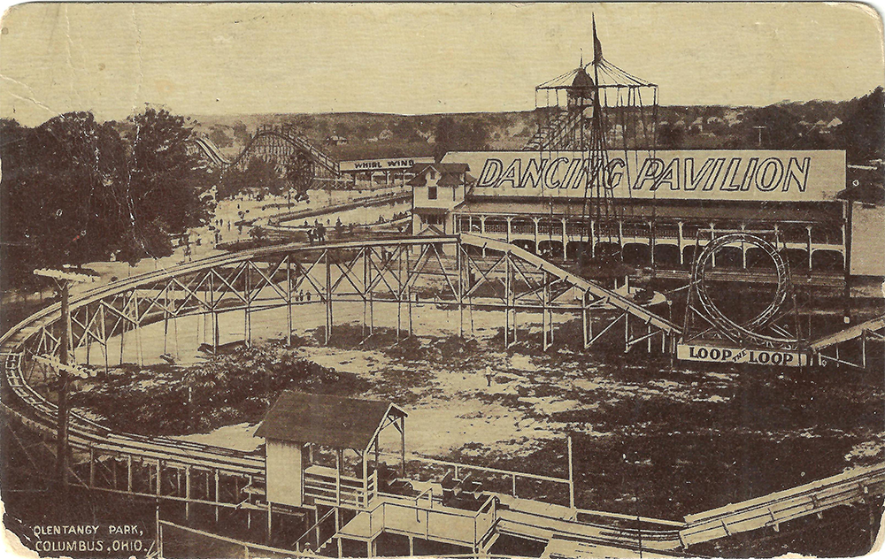 Vintage photo of Olentangy Park in Columbus, Ohio, featuring a roller coaster, a sign reading “Dancing Pavilion,” and another labeled “Loop-the-Loop.” People are visible walking and gathering in the amusement park.